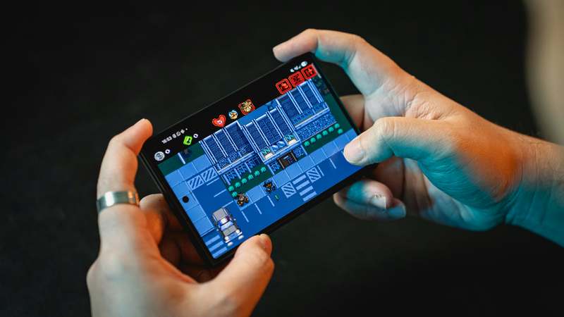 Bright smartphone screen showing colorful casual mobile game interface with candy crush-style tiles and cheerful UI elements on a soft pastel background